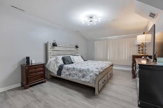 bedroom featuring vaulted ceiling, baseboards, visible vents, and a notable chandelier