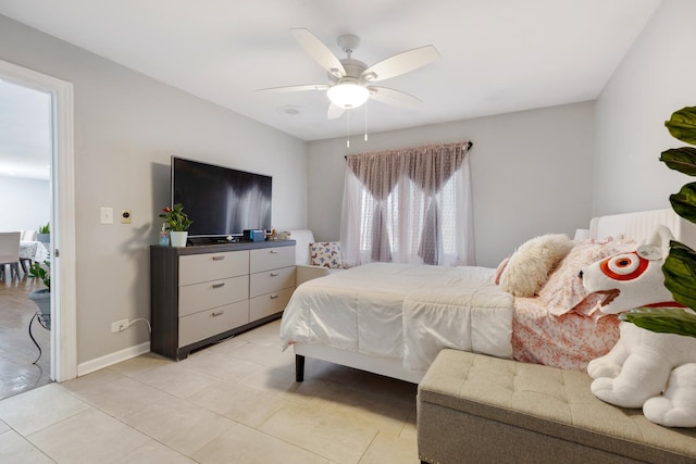 bedroom with ceiling fan, baseboards, and light tile patterned floors