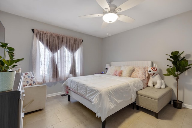 bedroom featuring light tile patterned floors, ceiling fan, and baseboards