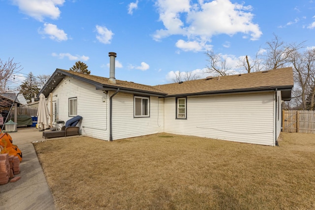 back of house featuring a patio area, fence, and a yard