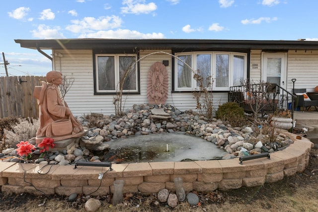 view of front of house featuring fence