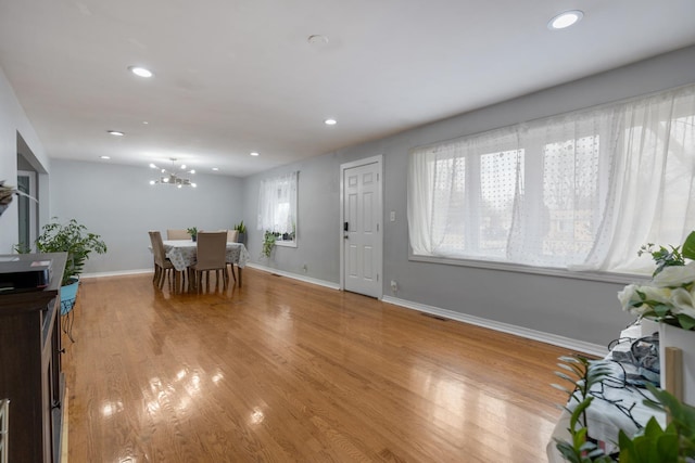 dining room featuring baseboards, a healthy amount of sunlight, recessed lighting, and light wood-style floors