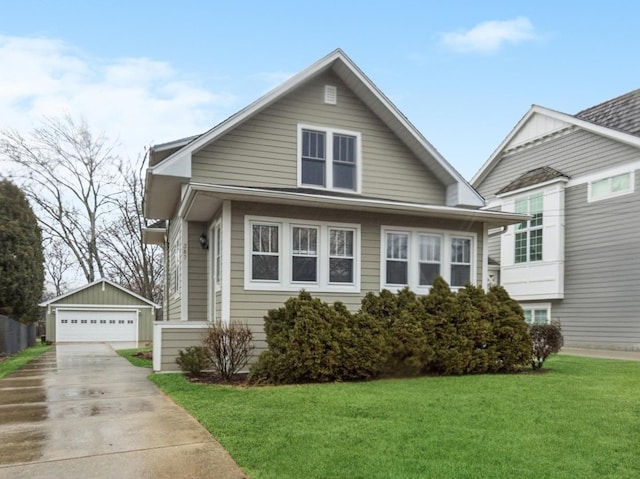 bungalow-style house featuring an outbuilding, a front lawn, and a detached garage