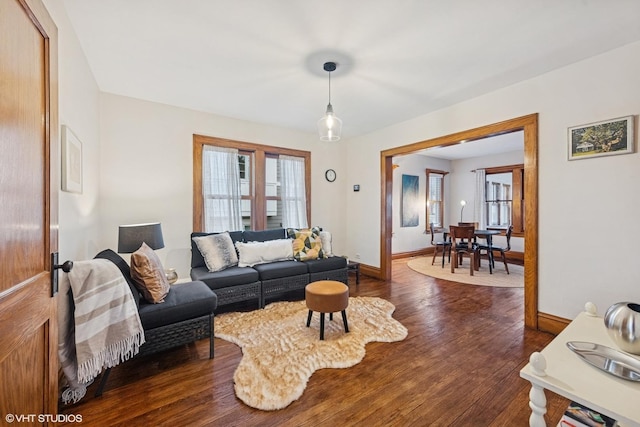 living room featuring dark wood finished floors and baseboards