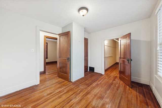 unfurnished bedroom with light wood-type flooring and baseboards