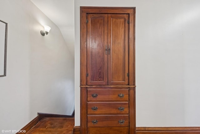 interior space with baseboards and wood finished floors