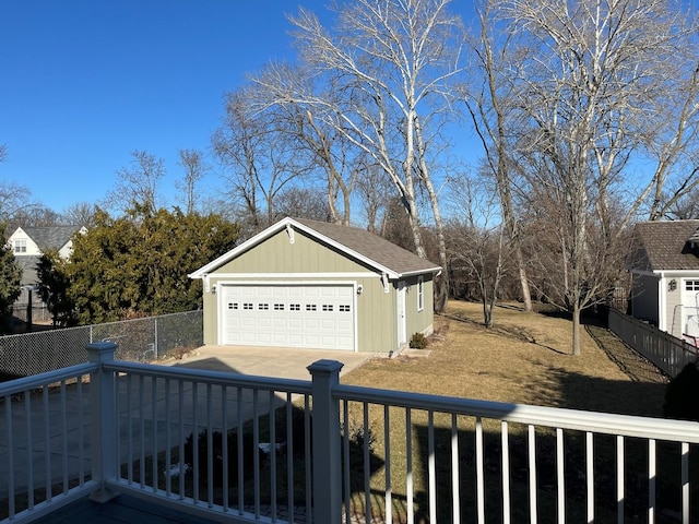 view of yard featuring an outbuilding, concrete driveway, and fence