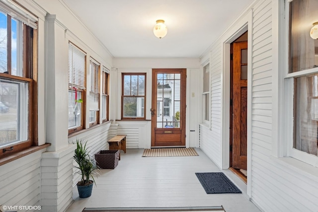 entryway featuring crown molding and wood finished floors