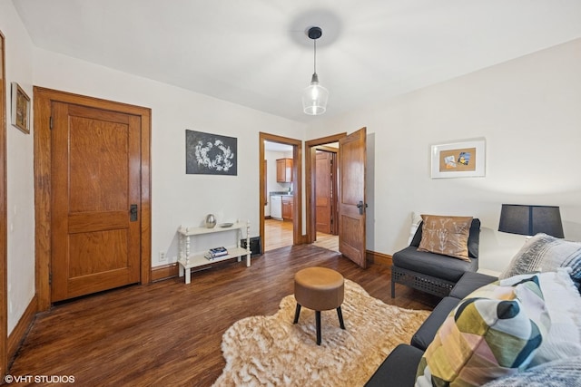 living area featuring dark wood finished floors and baseboards