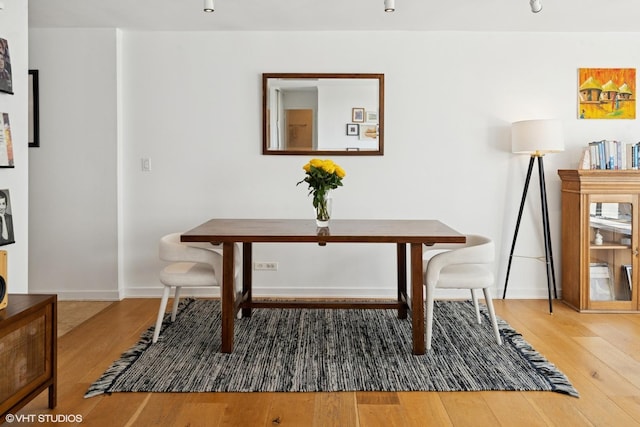 dining room with wood finished floors and baseboards