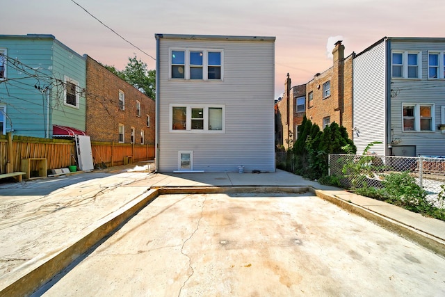 rear view of property with a patio area and a fenced backyard