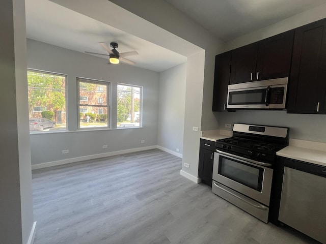 kitchen featuring appliances with stainless steel finishes, light countertops, and dark cabinetry