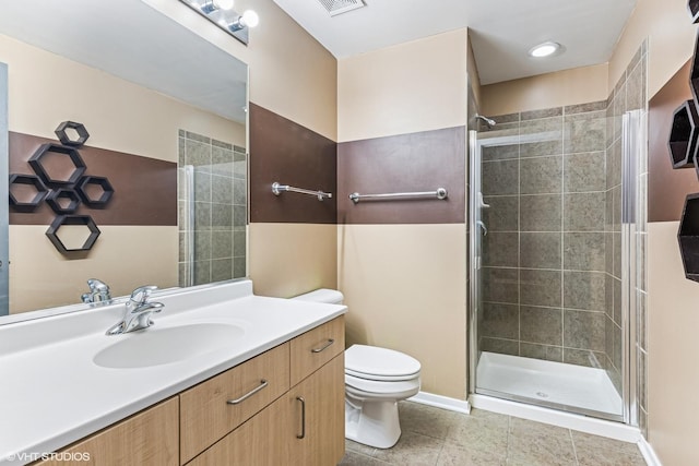 full bathroom with vanity, visible vents, a stall shower, tile patterned flooring, and toilet