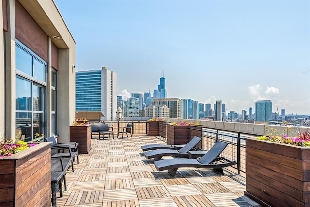 view of patio featuring a balcony and a city view