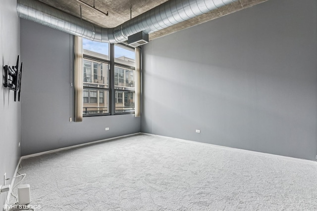 unfurnished room featuring baseboards and carpet floors