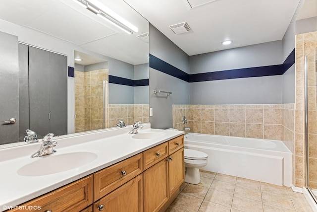 bathroom with tile patterned floors, visible vents, a bath, and a sink