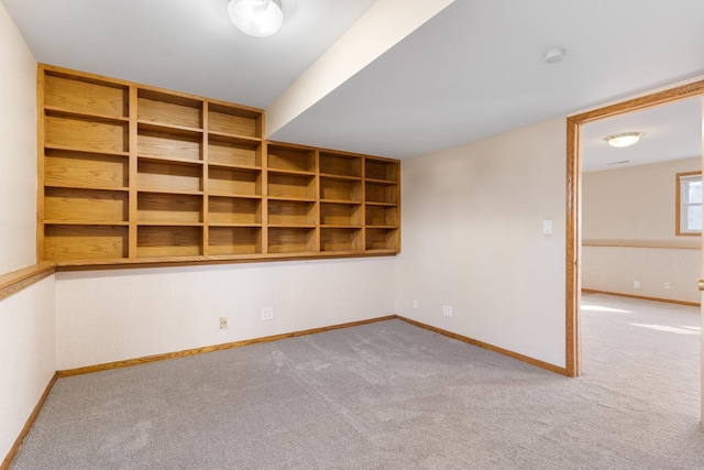 carpeted spare room with baseboards