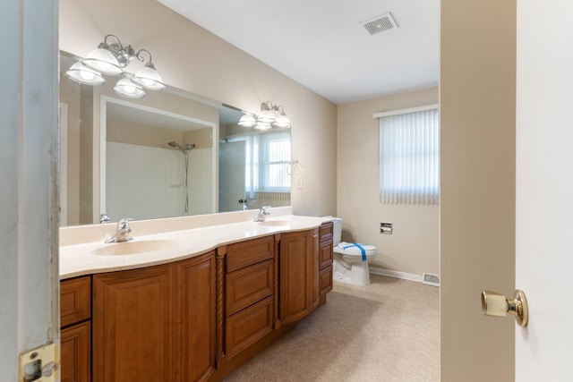 full bathroom featuring toilet, double vanity, visible vents, and a sink