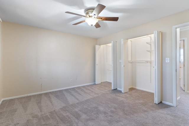 unfurnished bedroom with ceiling fan, carpet flooring, and baseboards