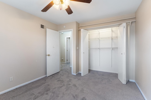 unfurnished bedroom featuring ceiling fan, carpet flooring, visible vents, baseboards, and a closet