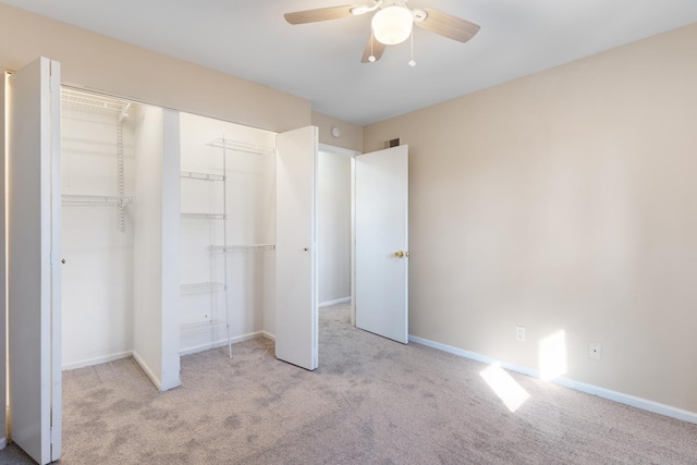 unfurnished bedroom featuring a closet, carpet flooring, visible vents, and baseboards