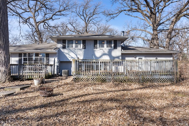 view of front facade with a deck, a fire pit, and central AC unit