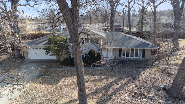 tri-level home with driveway and an attached garage