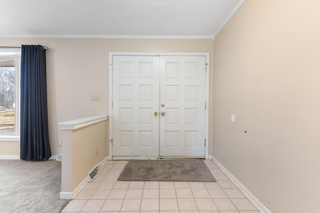 foyer featuring crown molding, light tile patterned floors, light colored carpet, visible vents, and baseboards