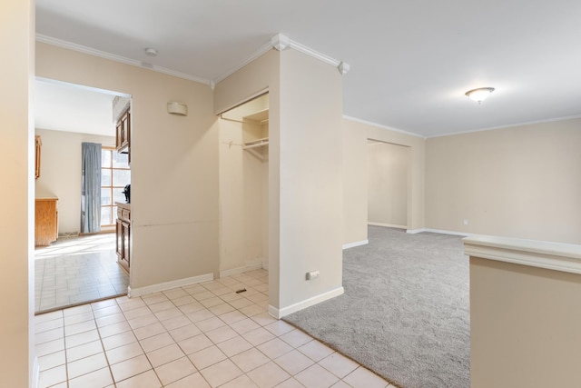 unfurnished room featuring baseboards, light tile patterned flooring, and crown molding