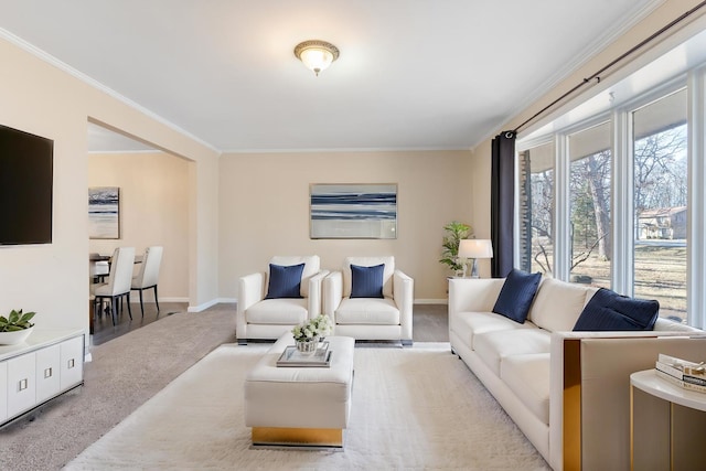 carpeted living room with baseboards and ornamental molding