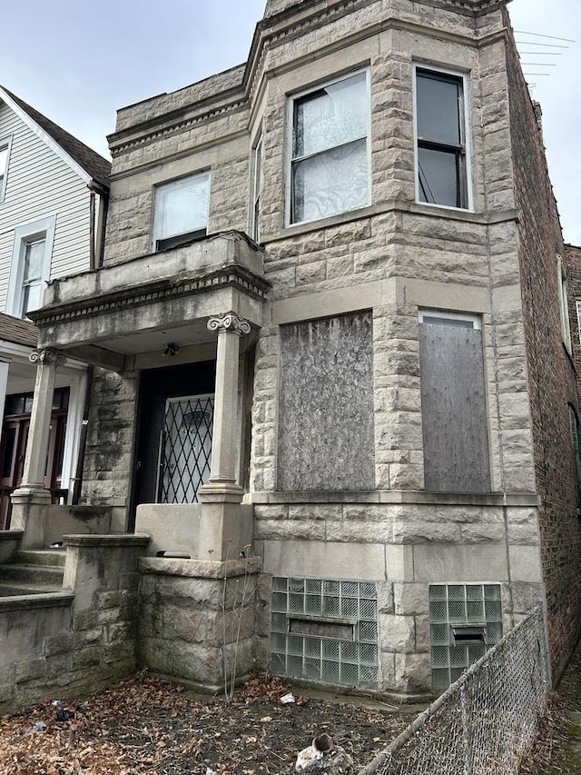 exterior space featuring stone siding