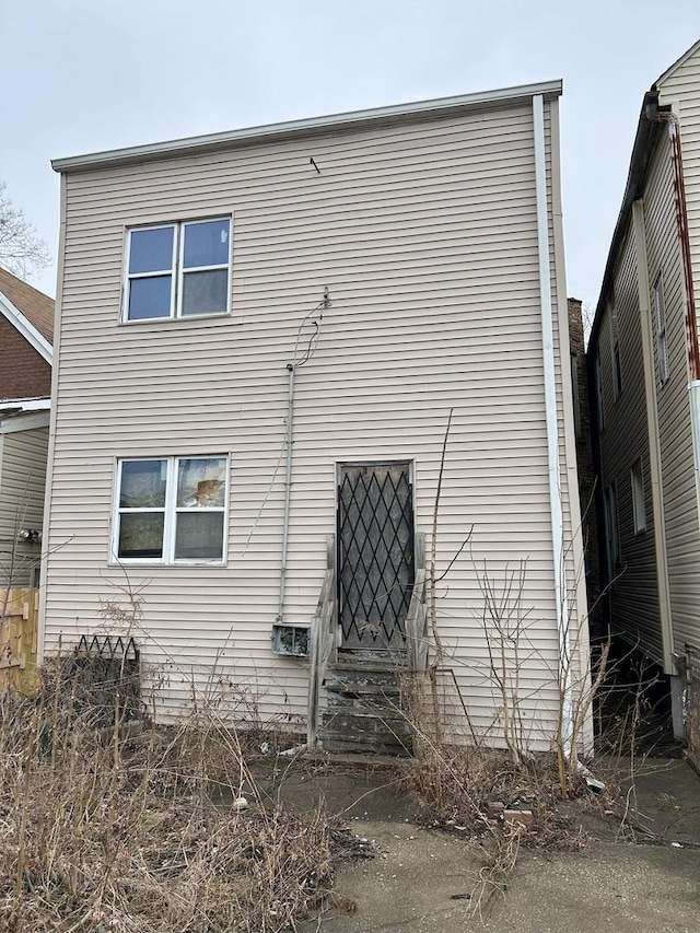 rear view of property featuring entry steps