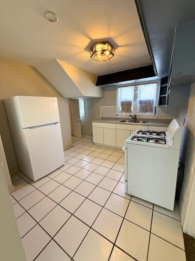 kitchen with light tile patterned floors, white appliances, a sink, white cabinetry, and light countertops