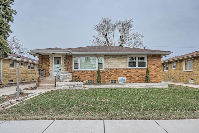 ranch-style house featuring a front lawn, roof with shingles, and brick siding