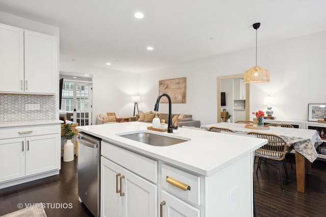 kitchen featuring dishwasher, a sink, dark wood finished floors, and decorative backsplash