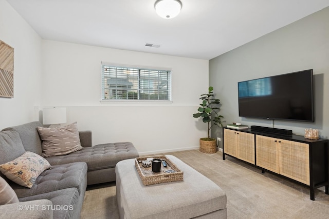 living room featuring baseboards, visible vents, and light colored carpet