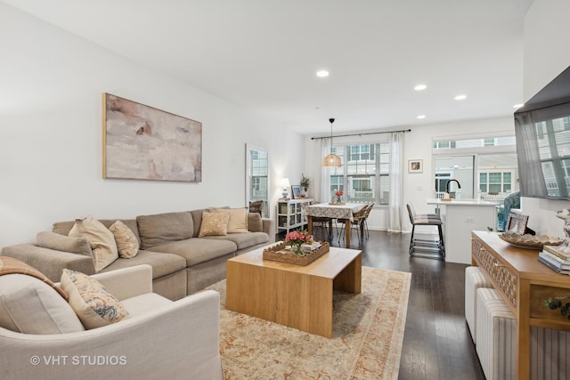 living area featuring dark wood-type flooring and recessed lighting