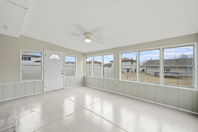 unfurnished sunroom with ceiling fan, lofted ceiling, and visible vents