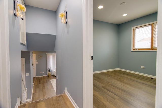 corridor with recessed lighting, wood finished floors, visible vents, and baseboards