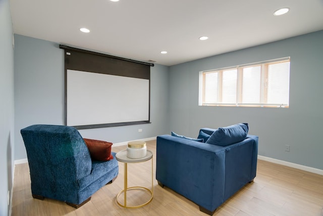 home theater room with light wood-style floors, recessed lighting, and baseboards