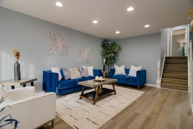 living area featuring recessed lighting, light wood finished floors, and stairs