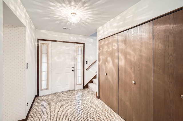 interior space featuring visible vents, stairway, and baseboards