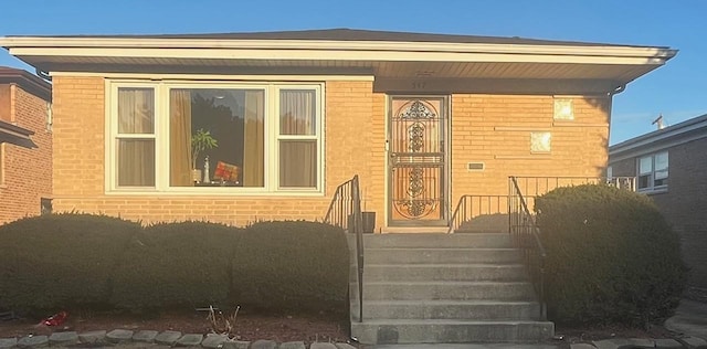 exterior space featuring covered porch and brick siding