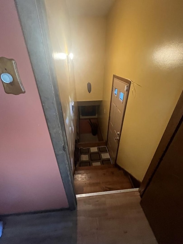 stairway with wood finished floors