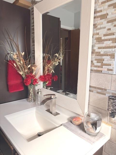 bathroom featuring vanity and tile walls