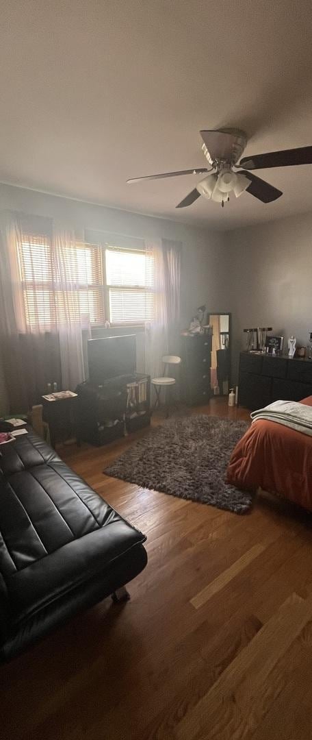 bedroom with ceiling fan and wood finished floors