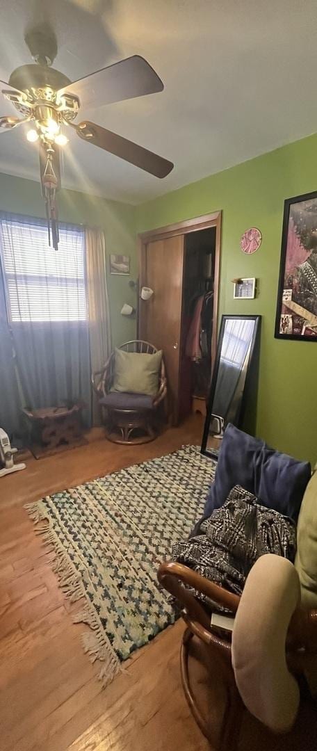 sitting room featuring ceiling fan and wood finished floors