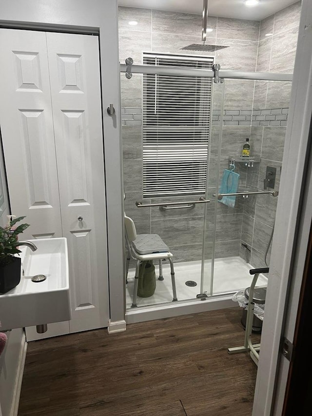 bathroom featuring a stall shower and wood finished floors