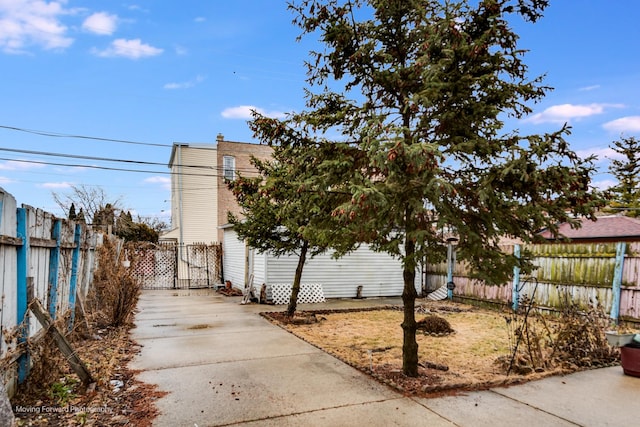 view of side of property featuring fence