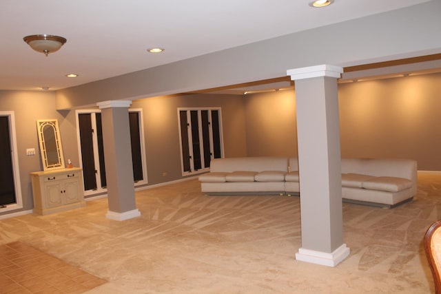 below grade area featuring baseboards, recessed lighting, and light colored carpet